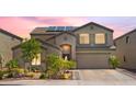 Charming exterior of a two-story home featuring solar panels, a well-manicured lawn, and a two-car garage at 23523 N 117Th Dr, Sun City, AZ 85373