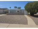 Charming single-story home featuring a well-maintained lawn and cozy covered parking at 2528 N Lema Dr, Mesa, AZ 85215