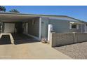 Charming single-story home featuring a well-maintained lawn and cozy covered parking at 2528 N Lema Dr, Mesa, AZ 85215