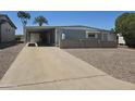 Charming single-story home featuring a well-maintained lawn and cozy covered parking at 2528 N Lema Dr, Mesa, AZ 85215