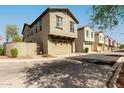 Neighborhood street featuring multiple homes, each with attached garages and well-kept landscaping at 2540 N Stone Hill Rd, Buckeye, AZ 85396