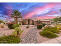 Expansive home featuring desert landscaping and a dramatic sunset at 3733 E Kachina Dr, Phoenix, AZ 85044