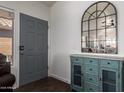 Stylish entryway with a blue cabinet, mirror, and a gray front door at 38662 N La Grange Ln, San Tan Valley, AZ 85140