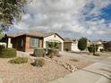 Attractive single-story home featuring desert landscaping, tile roof, and a mix of stucco and brick facade at 4440 S Leisure Way, Gilbert, AZ 85297