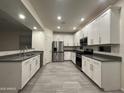 Bright, modern kitchen with white cabinetry, stainless steel appliances, and a spacious layout with tiled floors at 4440 S Leisure Way, Gilbert, AZ 85297