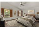 Bright bedroom featuring shuttered windows, vaulted ceilings and neutral decor for a calming and elegant aesthetic at 4544 E Campo Bello Dr, Phoenix, AZ 85032