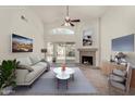 Bright living room featuring a fireplace, stylish furniture, and sliding doors to the backyard at 4544 E Campo Bello Dr, Phoenix, AZ 85032