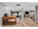 Open floor plan with a view from the kitchen to the living area, stainless steel appliances, and wooden island at 5325 E Thunderbird Rd, Scottsdale, AZ 85254