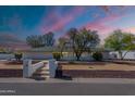 Charming single story home featuring tidy front yard and vibrant twilight sky at 5539 E Dahlia Dr, Scottsdale, AZ 85254
