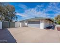 Spacious two-car garage with a neutral door and ample driveway space surrounded by a secure fence at 5539 E Dahlia Dr, Scottsdale, AZ 85254