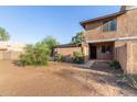 Exterior view of a two-story townhome featuring desert landscaping and a covered front porch at 6902 W Devonshire Ave # 1280, Phoenix, AZ 85033