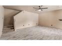 Spacious living room with tile floors, a ceiling fan, and access to the stairs at 6902 W Devonshire Ave # 1280, Phoenix, AZ 85033