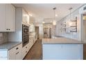 Modern kitchen featuring white cabinets, granite countertops, and stainless steel appliances at 717 W Chilton St, Chandler, AZ 85225