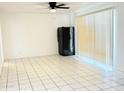 Bright living room featuring tiled floor, black refrigerator, and ceiling fan at 7202 N 36Th Ave, Phoenix, AZ 85051
