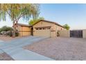 Single-story home featuring desert landscaping, a two-car garage, and neutral tones at 7607 W Keim Dr, Glendale, AZ 85303