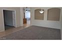 Open living room showcasing the decorative lighting, tile, and carpet at 8014 W Beaubien Dr, Peoria, AZ 85382