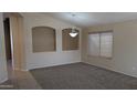Open-concept living room with carpet and a decorative lighting fixture at 8014 W Beaubien Dr, Peoria, AZ 85382