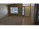 Spacious living room with carpeted floors and large windows at 8014 W Beaubien Dr, Peoria, AZ 85382