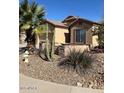 Single-story tan home features desert landscaping, a stone facade, and a decorative fountain at 840 W Crooked Stick Dr, Casa Grande, AZ 85122