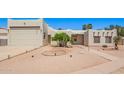 Stylish home with desert landscaping, a two-car garage, and a neutral color palette at 1018 E Knoll St, Mesa, AZ 85203