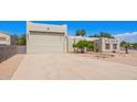 Stylish home with a large driveway, a two-car garage, and desert landscaping at 1018 E Knoll St, Mesa, AZ 85203
