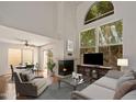 The well-lit living room showcases a fireplace, large windows, and stylish furnishings at 1095 W Sandy Banks --, Gilbert, AZ 85233