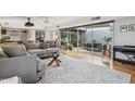 Bright living room boasts sleek hardwood floors, modern furnishings, and a wall of sliding glass doors at 110 W Missouri Ave # 18, Phoenix, AZ 85013