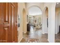 Elegant foyer featuring arched doorways, slate floors, and an open floorplan at 11462 E Kora Way, Scottsdale, AZ 85255