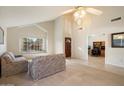 Large carpeted living room with high ceilings, natural lighting and views to the kitchen and entry at 11805 N 90Th Way, Scottsdale, AZ 85260