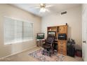 Cozy office space with a large window, built-in shelving, and a comfortable chair at 11805 N 90Th Way, Scottsdale, AZ 85260