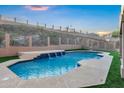 Swimming pool featuring a multi-tier waterfall and desert landscaping along mountain at 14049 S 8Th St, Phoenix, AZ 85048