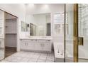 Elegant bathroom with double sinks, a large mirror, and a separate tub at 14470 N 98Th Pl, Scottsdale, AZ 85260