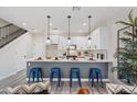 Stylish kitchen features a white island, modern appliances and breakfast bar seating at 1642 E Monte Vista Rd # 10, Phoenix, AZ 85006