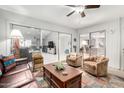 Bright living room with sliding glass doors, comfortable seating, and stylish decor at 18522 N Mica Dr, Sun City West, AZ 85375