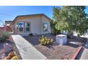 Desert home with easy-care landscaping, including native cacti and mature shade trees at 1855 N Rim Rock Dr, Casa Grande, AZ 85122