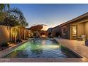 Inviting backyard oasis featuring a sparkling pool, fountain features, and relaxing seating areas perfect for outdoor entertaining at 21283 E Camacho Rd, Queen Creek, AZ 85142
