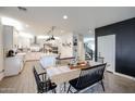 Bright dining room with stylish wood table and views of kitchen, perfect for Gathering gatherings and entertaining at 2158 N 212Th Ave, Buckeye, AZ 85396