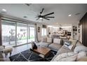 Open-concept living room flows seamlessly into the kitchen, creating a perfect space for modern living and entertaining at 2158 N 212Th Ave, Buckeye, AZ 85396