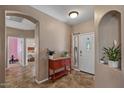 Inviting foyer with neutral walls, tile floors, and an accent cabinet creating a warm entrance to the home at 21720 E Domingo Rd, Queen Creek, AZ 85142
