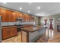 Modern kitchen with stainless steel appliances, updated cabinets, and a large island with bar seating at 21720 E Domingo Rd, Queen Creek, AZ 85142