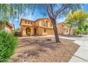 Attractive two-story home with a well-kept lawn, mature trees, and pleasant street view at 2306 W Spur Dr, Phoenix, AZ 85085