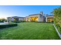 Expansive backyard featuring lush green lawn, manicured hedges, and modern architecture at 24066 N 90Th Way, Scottsdale, AZ 85255