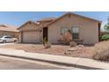 Charming single-story home with a two-car garage and low-maintenance desert landscaping at 25667 W Primrose Ln, Buckeye, AZ 85326