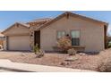 Charming single-story home with a two-car garage and low-maintenance desert landscaping at 25667 W Primrose Ln, Buckeye, AZ 85326