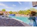 Stunning backyard pool and spa with desert landscaping, creating a serene outdoor oasis at 31107 N 27Th Ave, Phoenix, AZ 85085