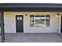 Inviting front porch featuring a stylish brick patio, modern lighting, and attractive front door at 3310 W Sweetwater Ave, Phoenix, AZ 85029