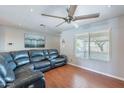 Inviting living room featuring modern ceiling fan, hardwood floors, and lots of natural light at 3408 W Carol Ave, Phoenix, AZ 85051