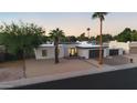 Single-story home with desert landscaping and mountain views in the background and a brick driveway at 3615 E Charter Oak Rd, Phoenix, AZ 85032