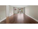 Open concept living room with hardwood floors and lots of natural light at 3825 E Camelback Rd # 117, Phoenix, AZ 85018