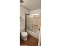 Cozy bathroom features a bathtub with glass sliding doors and a standard toilet at 4008 W El Caminito Dr, Phoenix, AZ 85051